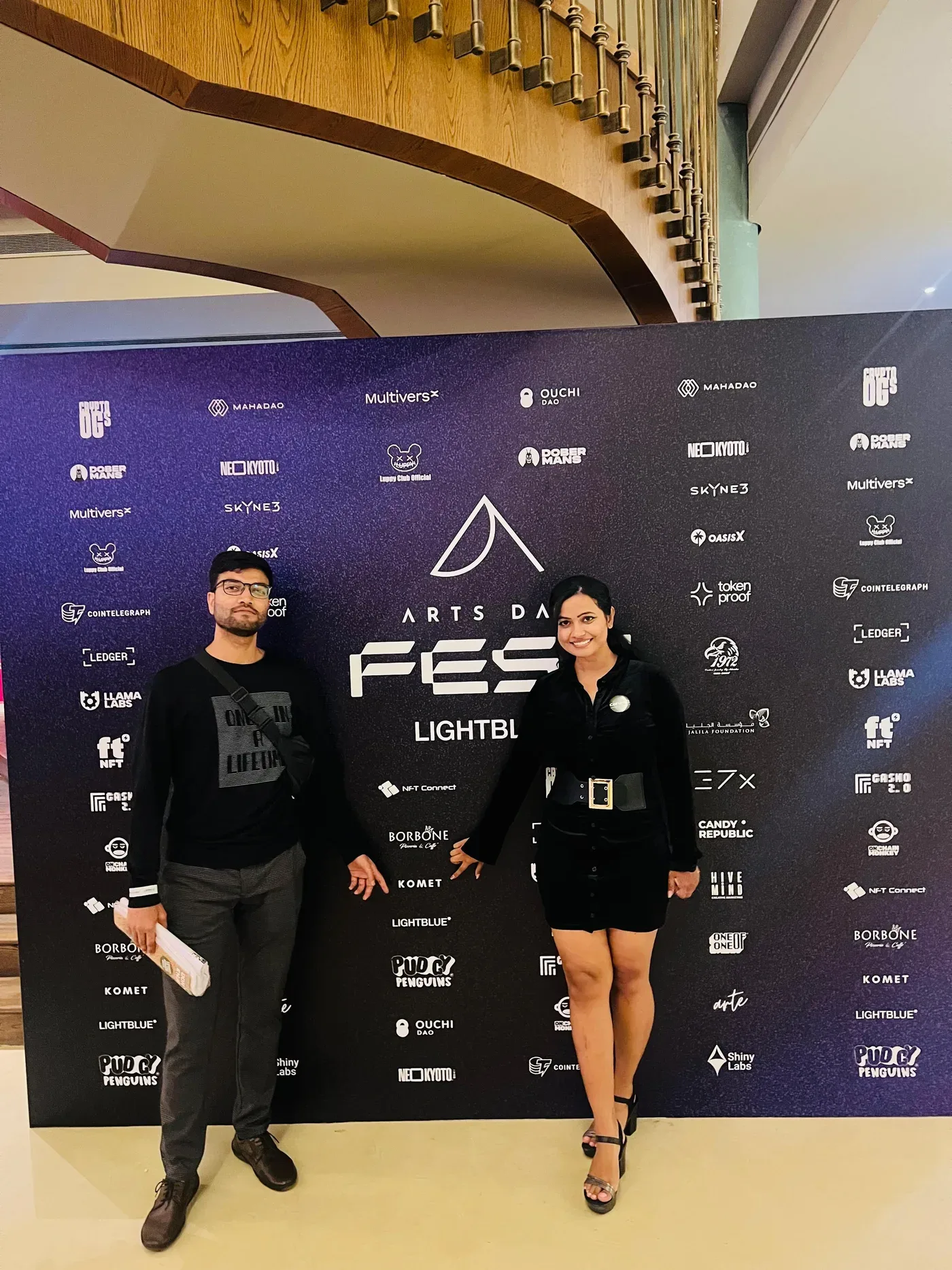 Corum8 team with a client at a festival media wall