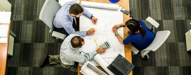 A team working through a plan around a table