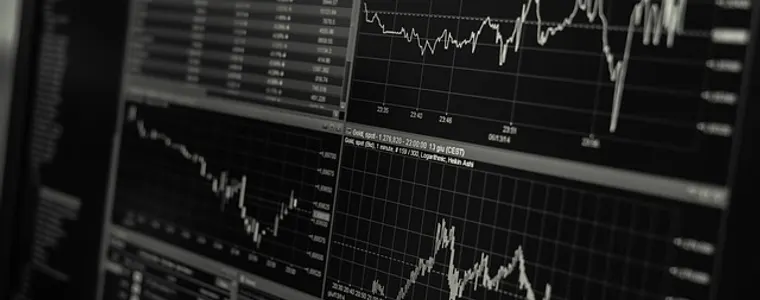 Trading desk monitors showing market data
